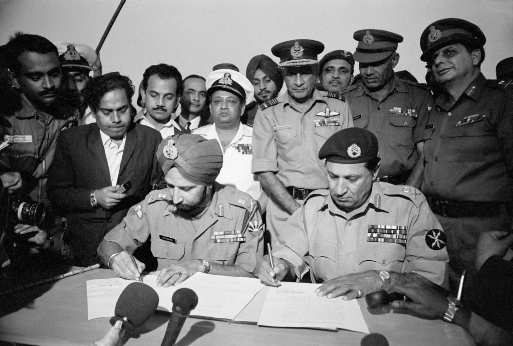 The current image has no alternative text. The file name is: general-jagjit-singh-aurora-general-amir-abdullah-khan-niazi-sign-papers-to-end-indo-pakistani-war-1971.webp